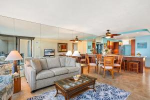 a living room with a couch and a table at Mahana 307 · MA 307 OceanFront Condo w Pool AC in Kahana