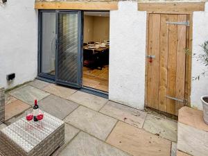 a patio with a table with two glasses of wine at Stone's Throw in Richmond