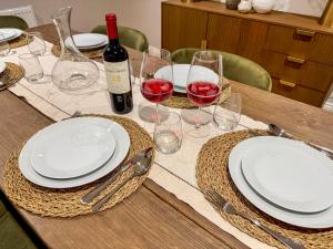 a table with white plates and glasses of red wine at Stone's Throw in Richmond