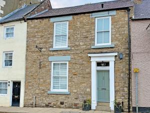 a brick house with white windows and a green door at Stone's Throw in Richmond +17 photos