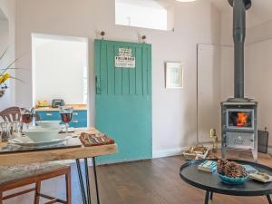 a kitchen with a blue door and a stove at The Cowshed - Uk50803 in Cratfield
