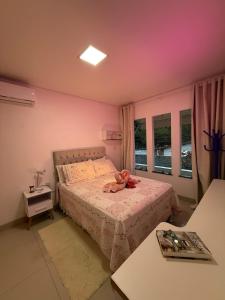 a bedroom with a bed with a teddy bear on it at Casa completa e climatizada em Ilhéus in Ilhéus +16 photos