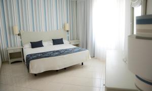 Postel nebo postele na pokoji v ubytování Ouril Pontao Hotel
