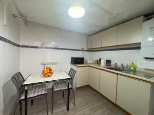 una cucina con un tavolo con una ciotola di frutta sopra di The Bluebird Porthmadog Retreat a Porthmadog