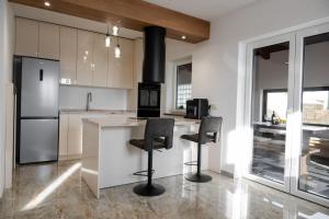 a kitchen with a counter with stools and a stove at Vila Mira in Gračišče