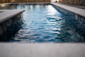 a swimming pool with blue water in a building at Vila Mira in Gračišče