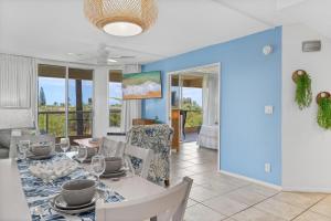 a dining room and living room with a table and chairs at Maui Banyan P301 · MB P301 Remodeled 2BD Condo Across Beach Pool in Wailea