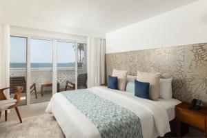 Un dormitorio con una cama con vista al mar. en Bamburi Beach Hotel, en Bamburi