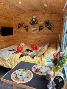 a room with two beds and a table with plates on it at Heron Leap in Knaresborough