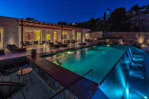 a swimming pool in a house at night at Elit Villa Psarou in Psarou