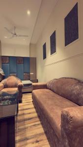 een woonkamer met een bank en een bed bij Hotel The SOHO in Chandīgarh