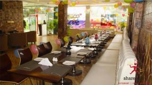a row of tables and chairs in a restaurant at Triple One Premier in Abbottabad
