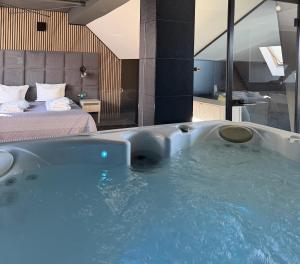 a large bath tub in a room with a bed at Hotel Jakuszyce Sport & Spa in Szklarska Poręba +65 photos