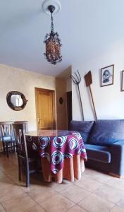 a living room with a table and a couch at Águila Real in Arroyo Frio