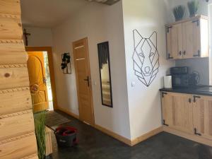 a room with a kitchen and a hallway with a door at Domki przy szlaku Szczebel in Lubień