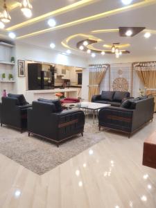 un salon avec des canapés, une table et une télévision dans l'établissement Cottage in Changla Gali - Secluded, Cozy Apartment, à Chhāngla Gali