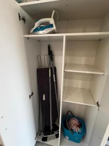 Un armario blanco con algunos artículos. en Beachside Studio Apartment with AC, en Costa de Adeje