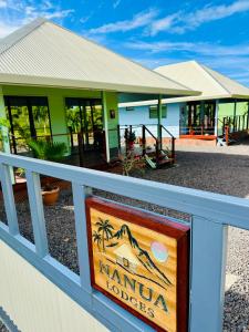 a sign on a fence in front of a kuana lodge at Nanua Lodge 1 green in Bora Bora