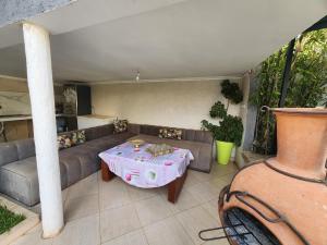 a living room with a couch and a table at Villa Luxe Fès avec Piscine & Spa, proche aéroport, Private Hammam in Fès