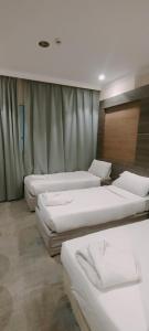 Ένα ή περισσότερα κρεβάτια σε δωμάτιο στο فندق دار المتكاملة 3