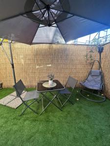a table and two chairs under an umbrella at WonderHouse casa vacanze in Boiano