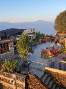 a house with a patio with a view of the mountains at Superview Lodge, Best Himalayan Sunrise in Sarangkot in Pokhara