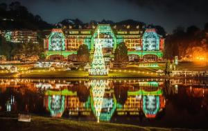 a large building with a reflection in the water at night at Jackie's Place in Petrópolis