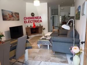 a living room with a couch and a tv at Apartamento Exclusivo - María 7 in Benaoján +20 photos