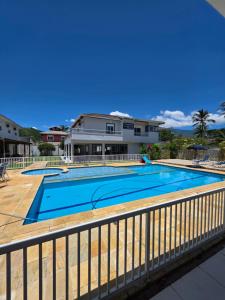 a swimming pool on a balcony of a house at Vila das Marés Beach Hotel in São Sebastião