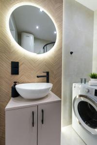 a bathroom with a sink and a washing machine at Modern Home in Sosnowiec +18 photos