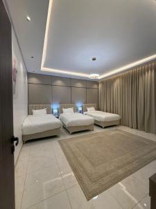 two beds in a room with two beds sidx sidx sidx at شقة البدر in Medina