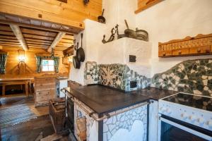 a kitchen with an island in a room with wooden ceilings at Schröckhütte in Bad Hofgastein +38 photos