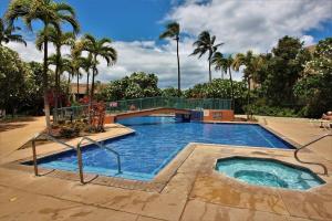a large swimming pool with palm trees in the background at Koa Resort 3J · KOA 3J Remodeled 3BD w AC Pool Near Sandy Beach in Kihei