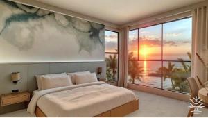 a bedroom with a large window with a view of the ocean at Coco Blue a New Beach Resort in La Libertad