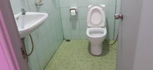 a bathroom with a toilet and a sink at Saran Resort room 9 in Ban Khok Wat