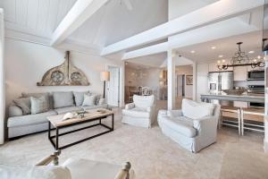 a living room with white furniture and a kitchen at SS3559: 3559 Seascape in Kiawah Island