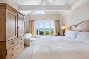 a white bedroom with a large bed and a window at SS3559: 3559 Seascape in Kiawah Island
