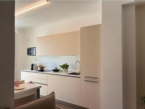a white kitchen with white cabinets and a sink at NORA Apartment 2 in Civitanova Marche