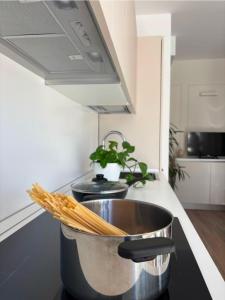 a large pot of pasta on a kitchen counter at NORA Apartment 2 in Civitanova Marche +7 photos
