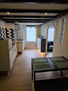 a kitchen and living room with a table in a room at Urban Oasis - BIG stylish Apartment in Schiedam