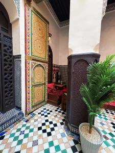 a room with a large door and a potted plant at Riad Panoramik in Fès