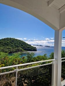 a view of the ocean from the balcony of a house at Les douceurs de la Baie Terre de Bas in Terre de Bas