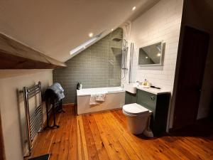 a bathroom with a toilet and a sink and a tub at "Ivyholme" Superb Premium House in Central Durham Location in Durham