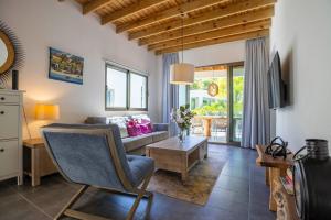 a living room with a couch and a table at ProCab Kaya Apartments Cabarete in Cabarete