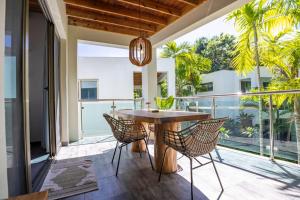 an outdoor patio with a wooden table and chairs at ProCab Kaya Apartments Cabarete in Cabarete