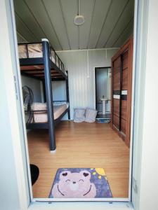 une chambre avec un lit superposé et un tapis dans l'établissement Inap Cabin, à Teluk Bahang 15 autres photos