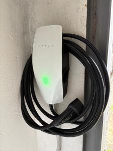 a black cord hooked up to a white object on a wall at Villetta Gabriella in Impruneta