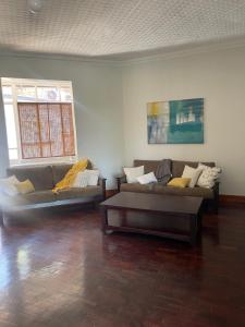 a living room with two couches and a coffee table at Lani Accommodation in Pretoria
