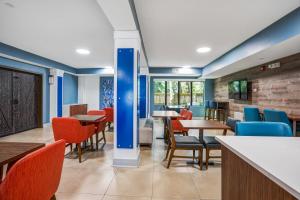 une salle à manger avec tables et chaises dans l'établissement Holiday Inn Express & Suites Jacksonville - Atlantic Beach by IHG, à Jacksonville