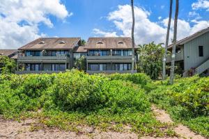 a large house with a lot of windows at Kahana Village 33 · KHV 33 Oceanfront 2BD Villa Spectacular Ocea in Kahana